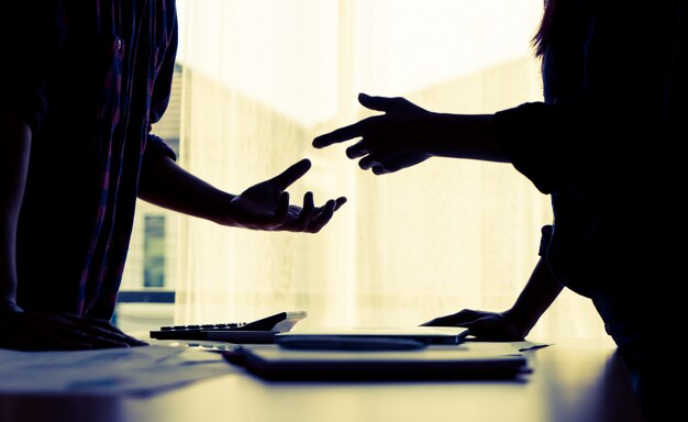 Silhouette Asian couple is fighting by the windows