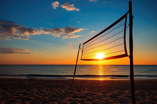 Silhouette of a beach volleyball net against the setting sun and ocean