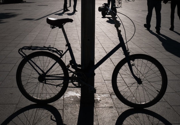 Silhouette of bike attached to the post.