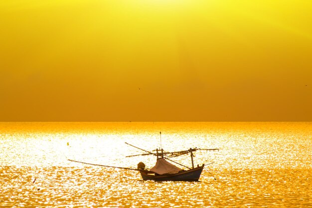 Silhouette boat on sea against clear sky