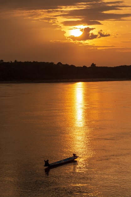 Silhouette boat in sea against sky during sunset