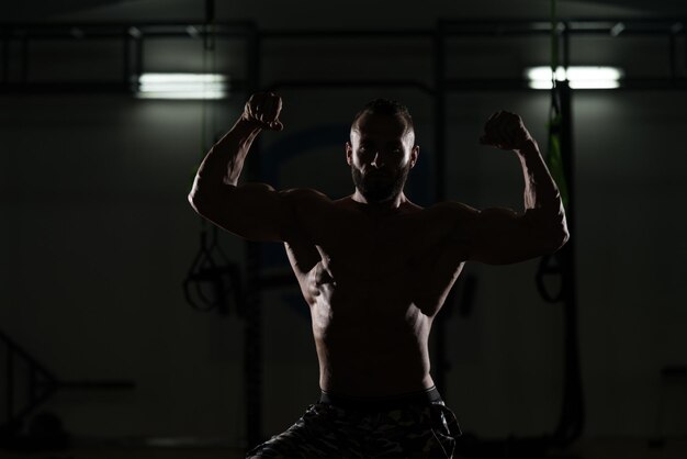 Silhouette Bodybuilder Flexing Muscles