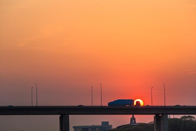 Silhouette bridge against sky during sunset