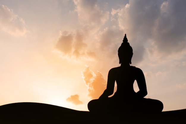 Silhouette of buddha at sunset