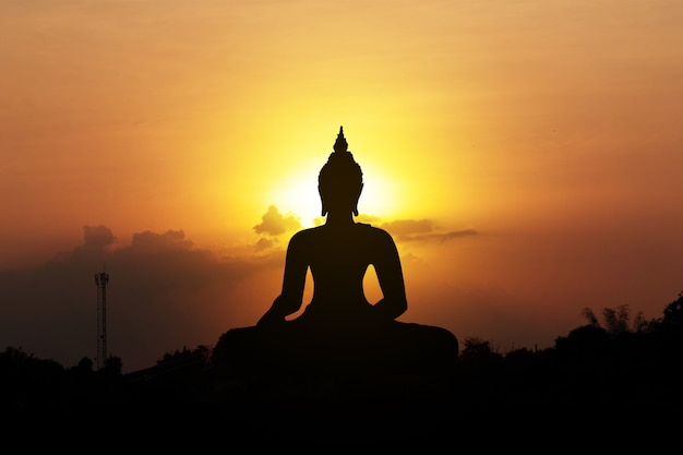 Silhouette of buddha at sunset