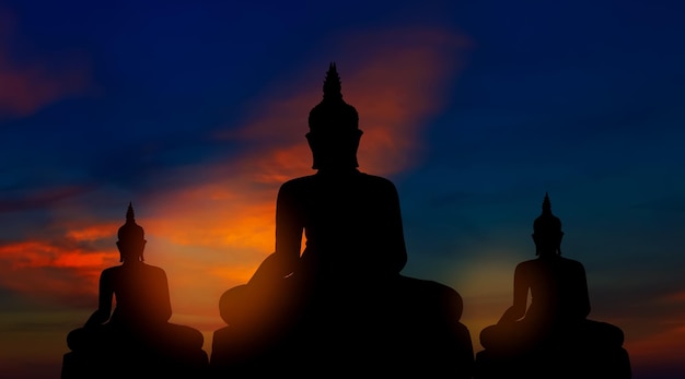 Silhouette of buddhas on golden sunset background buddhism beliefs