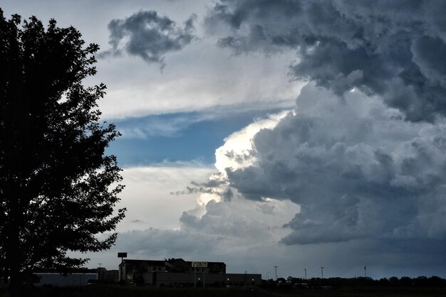 Silhouette of building against cloudy sky