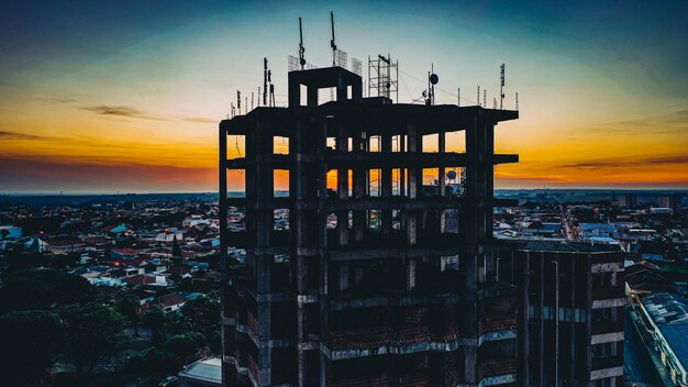 Silhouette of building against sky during sunset