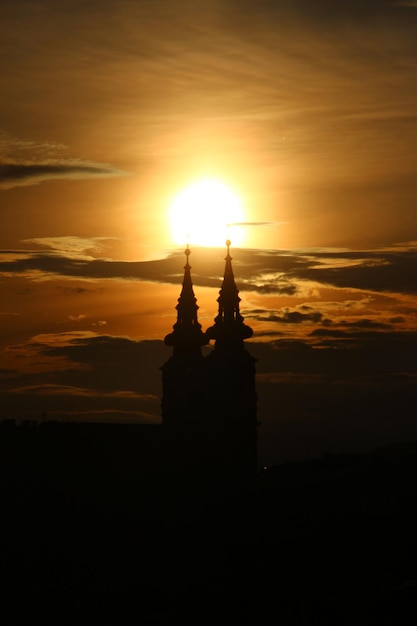 Silhouette of building against sky during sunset