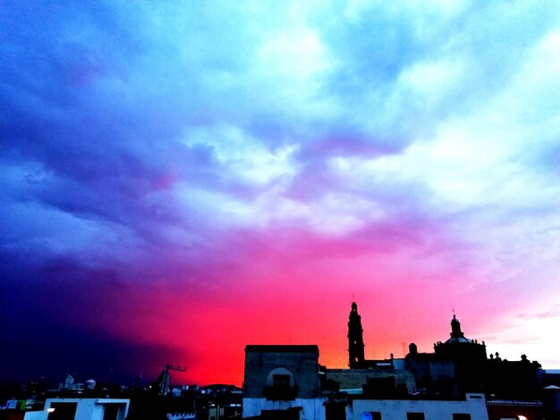 Silhouette of buildings against dramatic sky