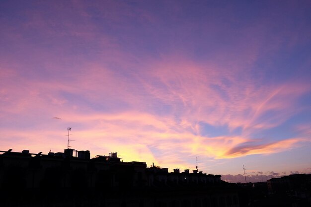 Silhouette buildings against dramatic sky