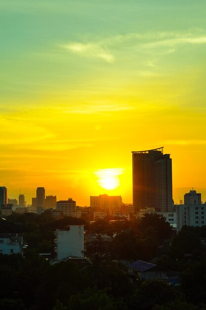 Silhouette buildings against sky during sunset