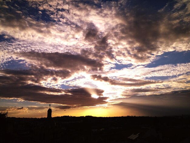 Silhouette buildings against sky during sunset