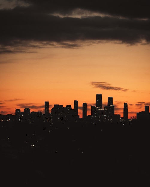 Silhouette buildings against sky during sunset