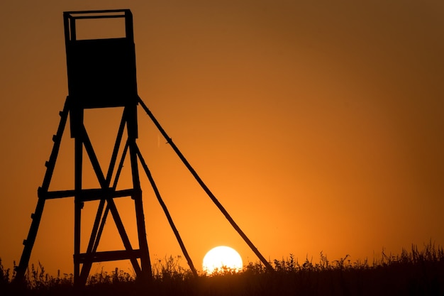 Silhouette built structure against clear sky during sunset