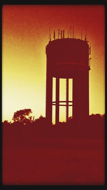 Silhouette of built structure at sunset