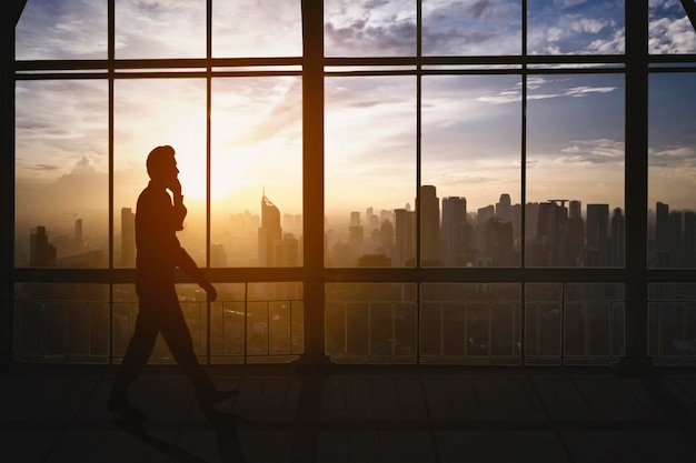 Silhouette of businessman calling on smartphone