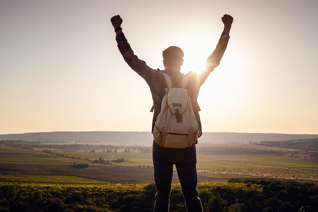 Silhouette of a champion on mountain peak Active life concept