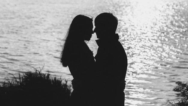 Silhouette of couple by the water