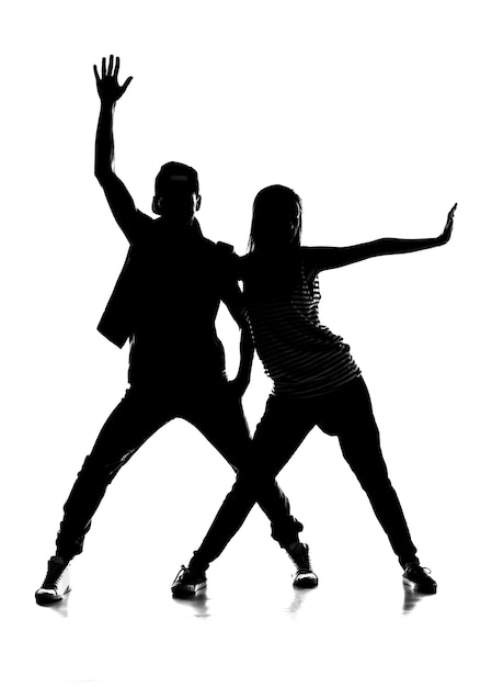 Silhouette of couple dancing hip-hop.