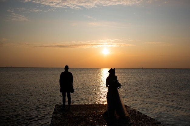 Silhouette of couple on sunset on the beach