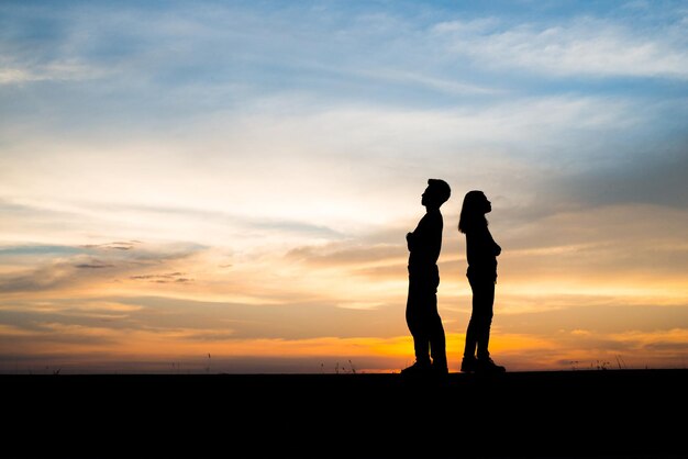 Foto silhouette di coppia sconvolta uomo e donne stanno litigando al tramonto