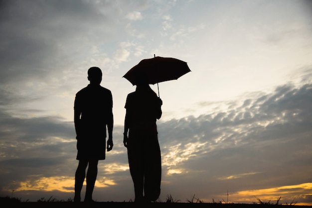 Silhouette of a couple with arguing in the sunset / concept arguing