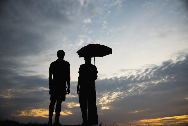 Silhouette of a couple with arguing in the sunset / concept arguing