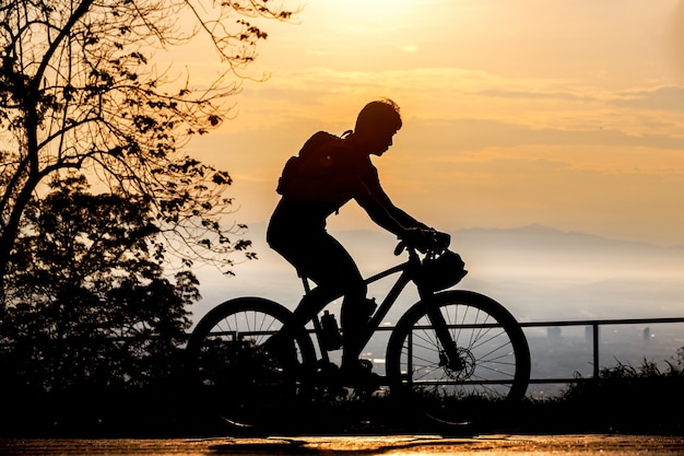 Silhouette of cyclist on mountainbiker at sunset