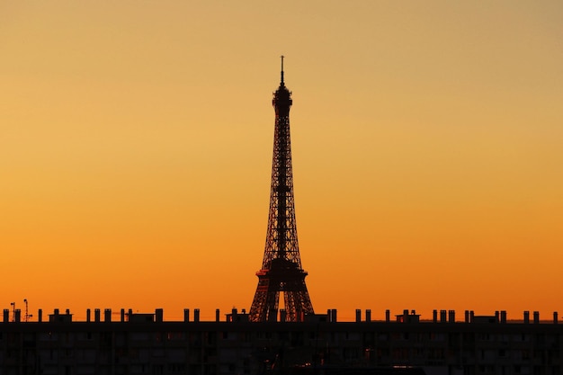 silhouette eiffel tower against orange sky