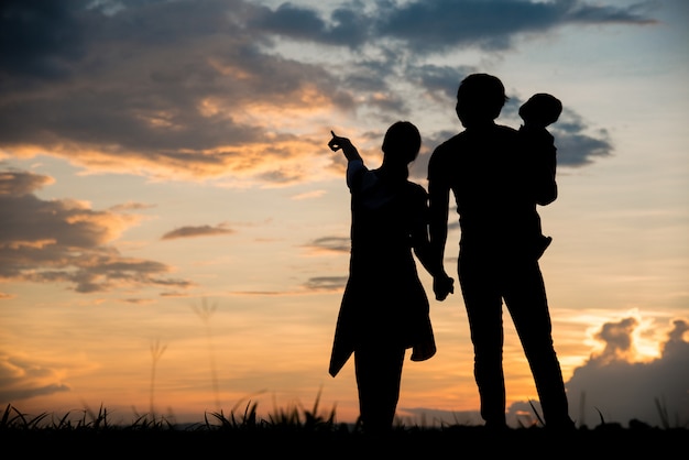 Silhouette of family happy parents having fun