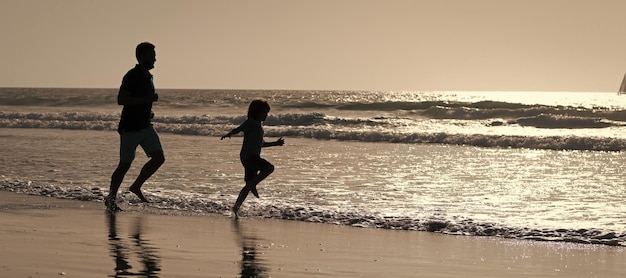 Silhouette of father and son run on summer beach outdoor banner poster with copy space Dad child