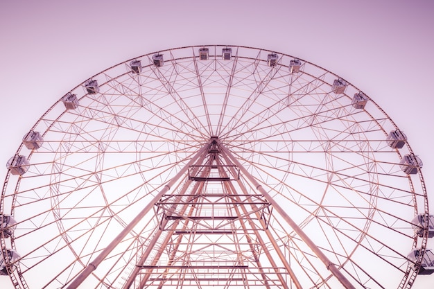 Silhouette of Ferris wheel on the background of blue sky