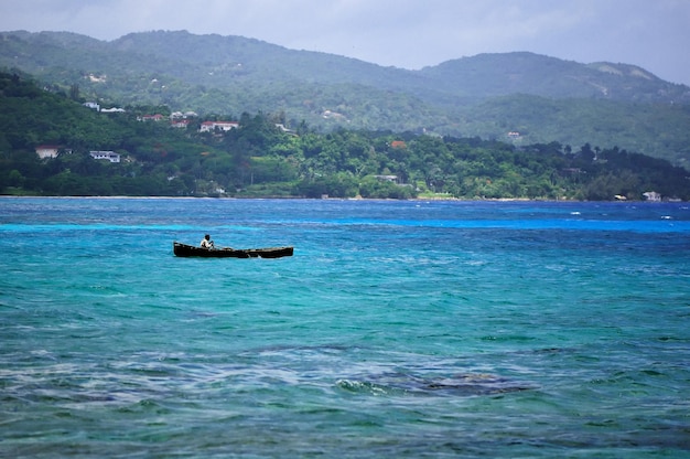 Silhouette of fisherman at stormz sea Montego bay beach Jamaica