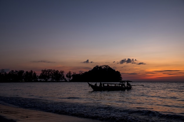 Silhouette, the fishing boat is to embed the evening.