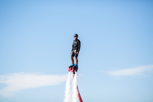 Silhouette of a fly board rider at sea