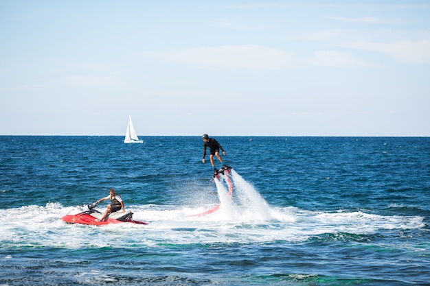 Silhouette of a fly board rider at sea