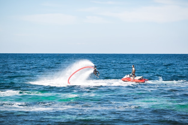 Silhouette of a fly board rider at sea