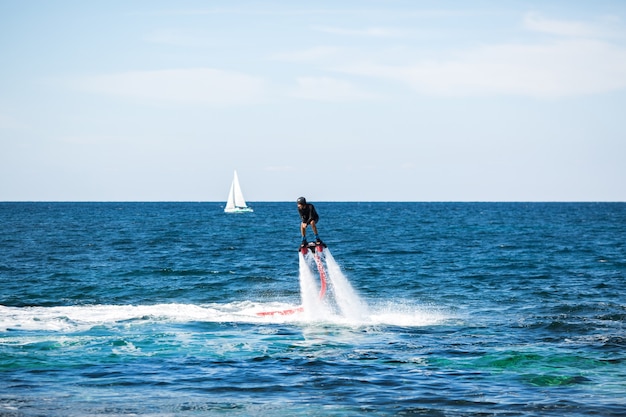 Silhouette of a fly board rider at sea