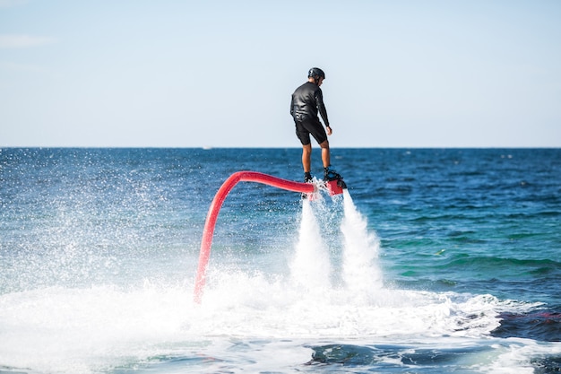 Silhouette of a fly board rider at sea