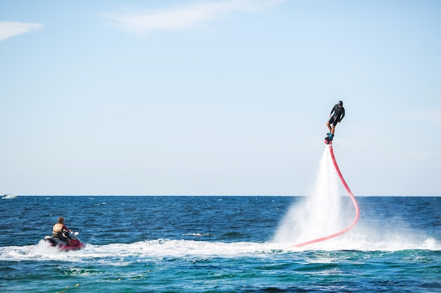 Silhouette of a fly board rider at sea