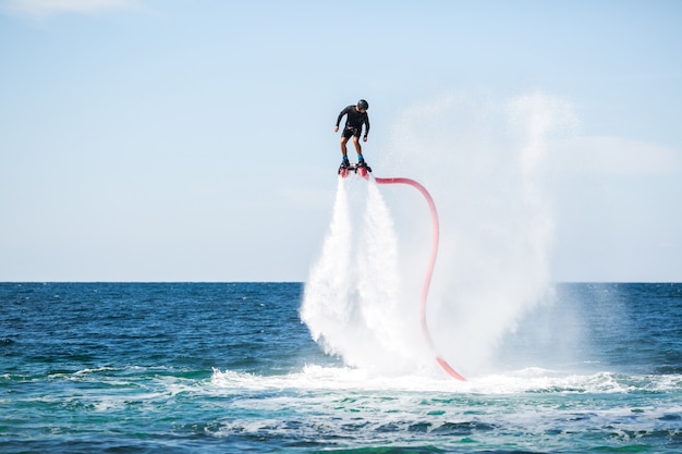 Silhouette of a fly board rider at sea