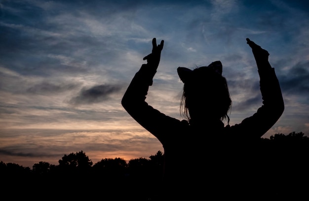 Silhouette of a girl against the sunset