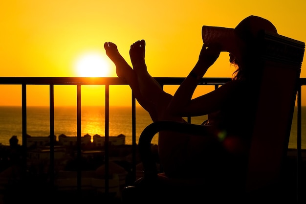 Silhouette of a girl on a chair on a nature background