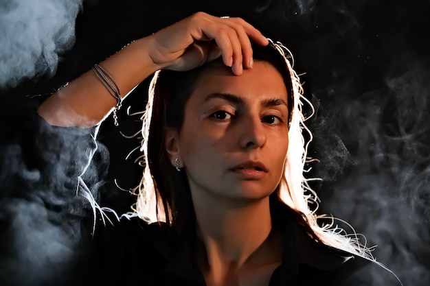 Silhouette of a girl in the dark smoke steam girl in a dark room