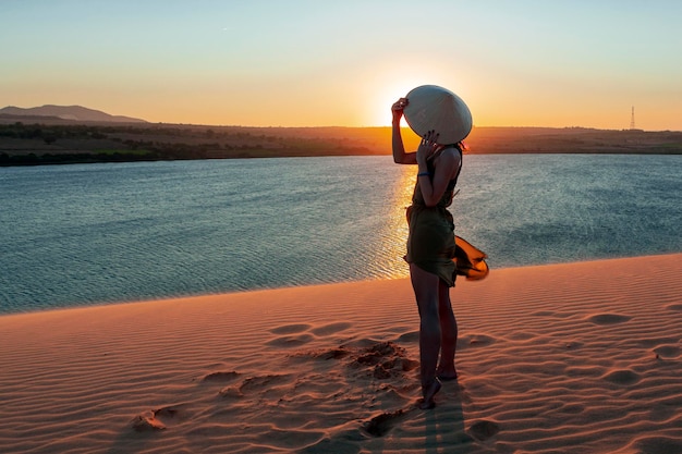 Silhouette of a girl in the dunes of the desert.