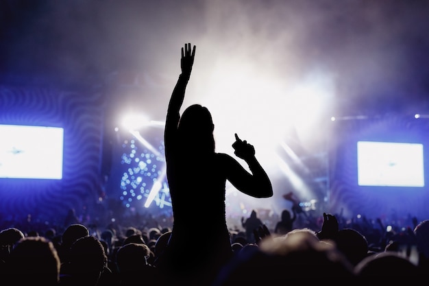 Silhouette of Girl enjoying the music festival, concert.