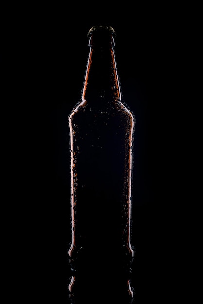 Silhouette of a glass bottle on a black background