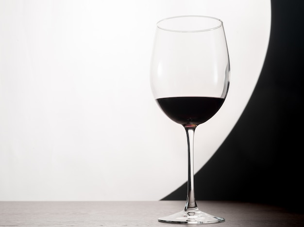 Silhouette of a glass of red wine on the table