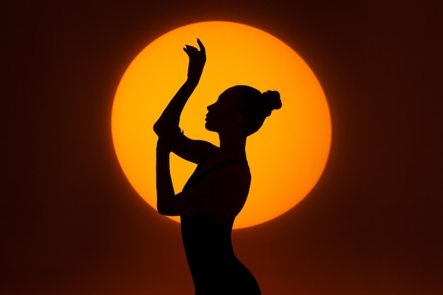 Silhouette of a gracefully dancing woman against the background of a circle of light Frame up strip